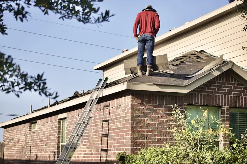 Professional roofer working on a residential roof in Farmers Corner
